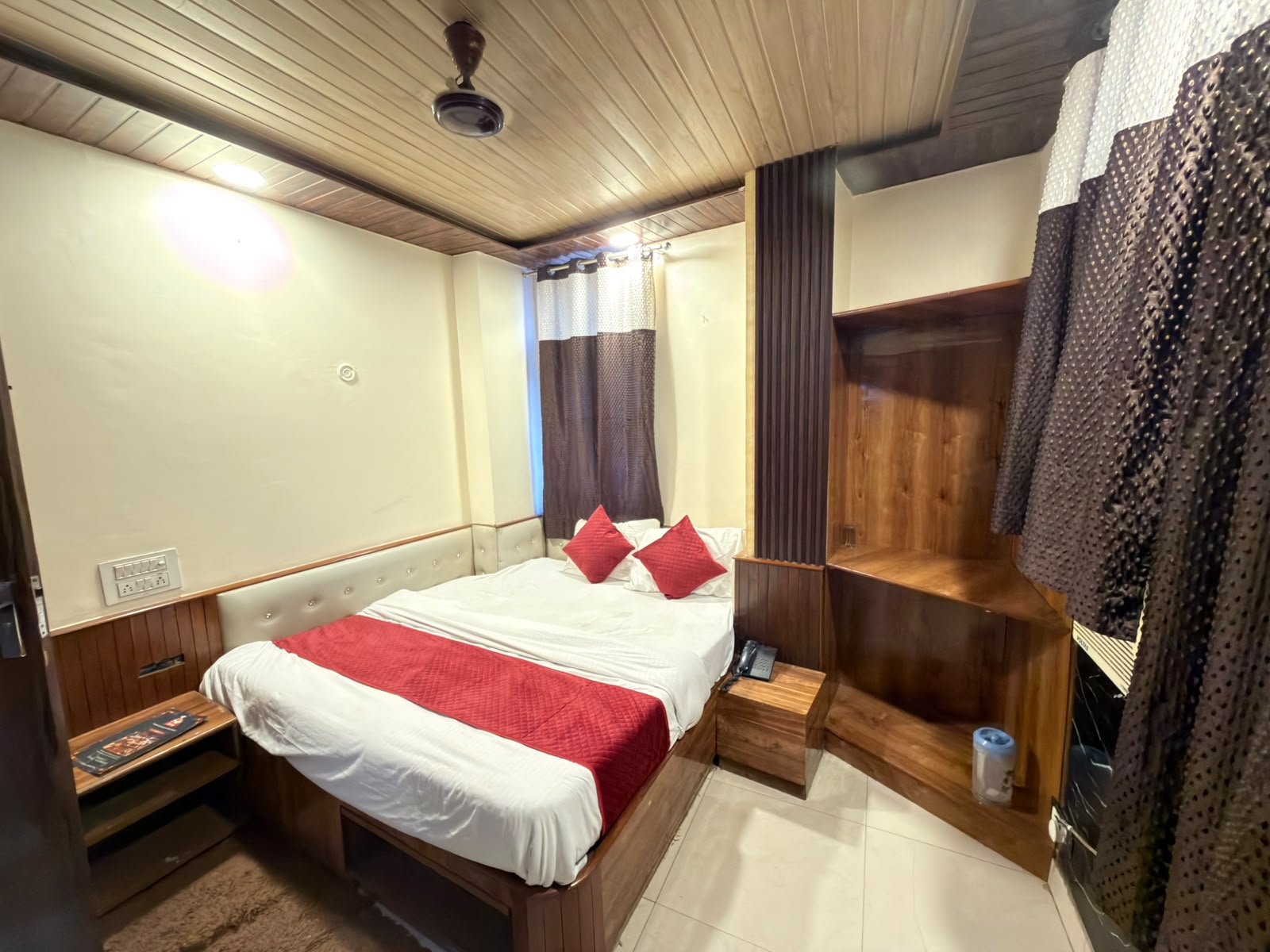 Double bed room at Hotel Vin Inn with a wide bed and wood panelling
